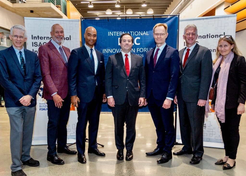 From left to right: Technical Director for FutureG Dr. Ted Woodward (left); Director of Applied Research for FutureG Dr. Martin Weiss; Deputy Principal Director for FutureG Mr. Marlan Macklin; Deputy Under Secretary of War Mr. James Mazol (middle); Under Secretary of State at Finland’s Ministry of Economic Affairs and Employment Mr. Petri Peltonen; Director of Advanced Component Development & Prototypes Dr. Carl Kutsche; Head of Development at Finland’s Ministry of Economic Affairs and Employment Ms. Jonna Lehtinen (right) at the International ISAC Innovation Forum on May 21, 2026.