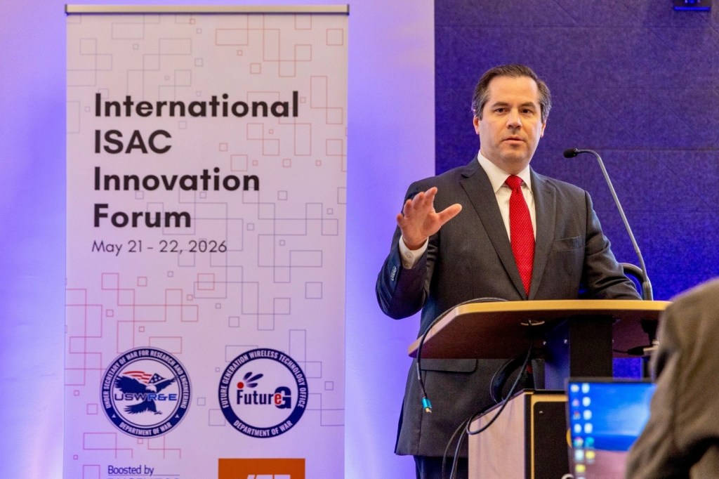 Deputy Under Secretary of War Mr. James Mazol giving keynote remarks at the International ISAC Innovation Forum on May 21, 2026. 